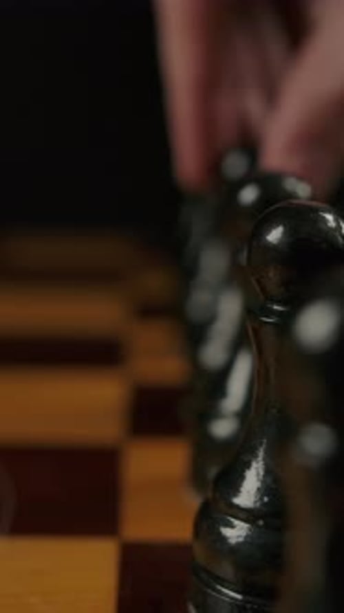 Vertical of Human's Hand Makes First Opponent Move By Black Pawn E7 E5 in Chess Game