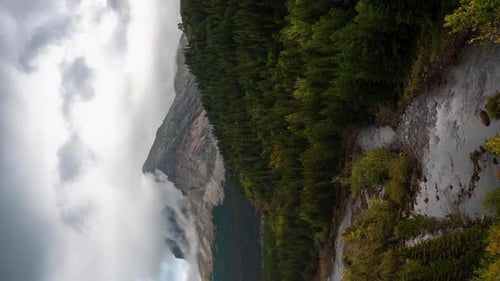 Vertical 4k Time Lapse, Dramatic Clouds Above Majestic Pristine Mountains Landscape Forest, Glacial