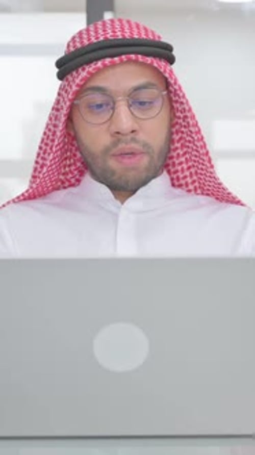 Adult Man in Traditional Dress Working on Laptop