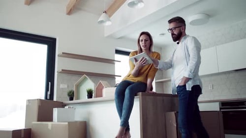 Happy Couple Moving into New Home with Boxes