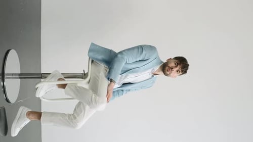 Stylish Young Adult Posing on Stool