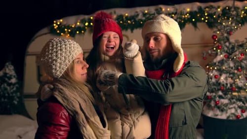 Happy Family Celebrating Christmas in Winter Wonderland