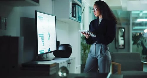 Woman Analyzing Data in Modern Office at Night