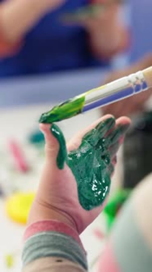 Student, child and painting on hand in classroom for creative project, art lesson