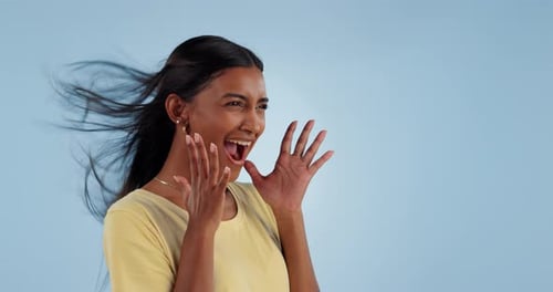 Happy, wind and woman in studio for celebration isolated on a blue background mockup space