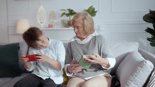 Grandmother and grandson relaxing on the couch together