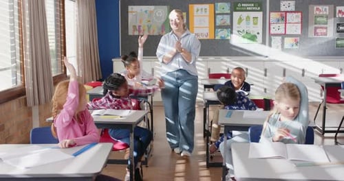 In school, female teacher interacting with students in classroom, engaging in discussion