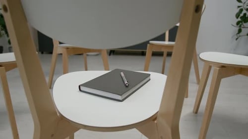 Close-up of Closed Notebook on Chair in Group Therapy Room