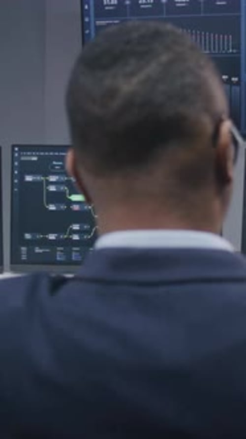 Software Programmer Sits in Front of Computer with Blockchain Network