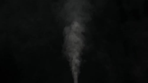 Slow motion of white smoke, fog, mist, vapor on a black background.