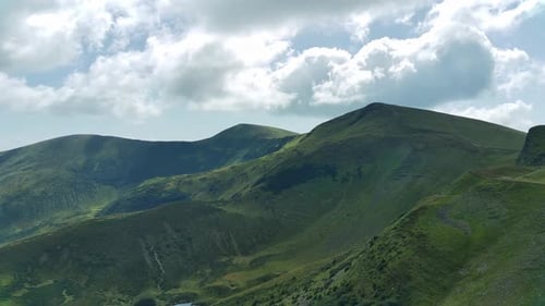 Lush Slopes Of The Carpathian Mountains Under The Blue Sky.