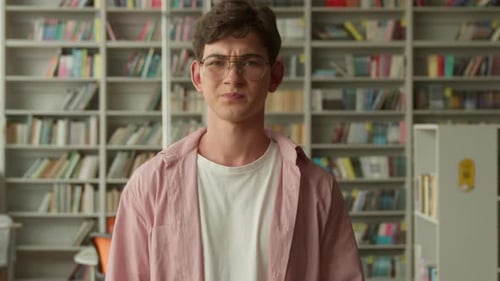 Upset Caucasian Student Guy Looking at Camera Showing Dislike Thumb Down School Library Book Shop