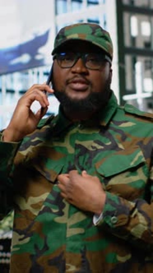Man in Military Uniform Talking on Cell Phone