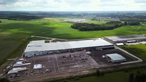 Realtime Footage of a Large Industrial Warehouse in a Rural Setting From an Aerial View with