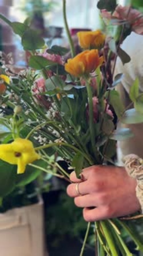 The Florist is Creating a Flower Arrangement in the Flower Store