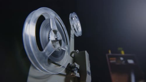 Vintage Movie Projector Playing Film in the Dark