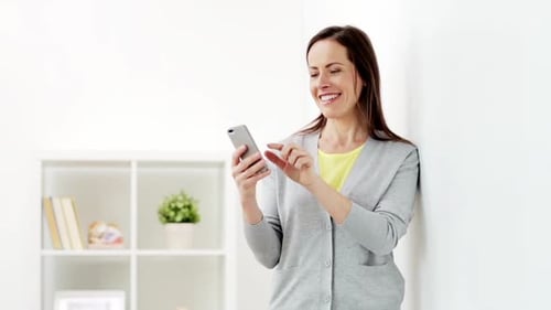 Woman Using Smartphone Device in Modern Apartment