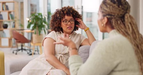 Two Women Conversing in a Sunny Living Room
