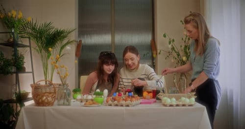 Sisters Painting Easter Eggs for Easter Holidays