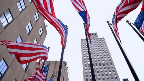 American Flags Waving Near Skyscrapers in New York City