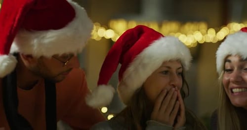 Authentic shot of happy young woman is opening Christmas present box from friends is excited and s