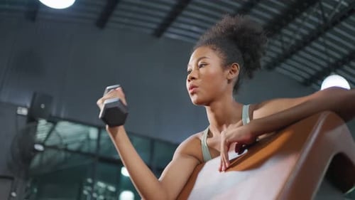 Young beautiful African american sportswoman exercise in gym stadium.