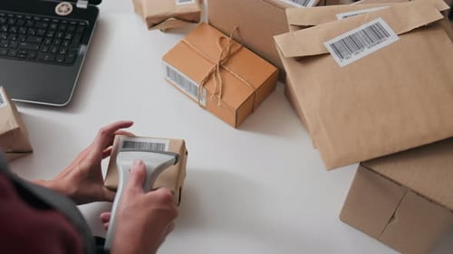 Worker Manager Scans The Goods Top View, The Scanner Scans The Barcode Labeled Box Parcel Shipment