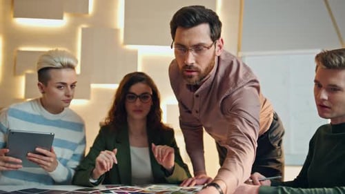 Diverse coworkers brainstorming business strategy in modern corporate office