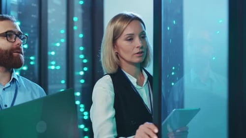 Adults Working With Technology In Server Room