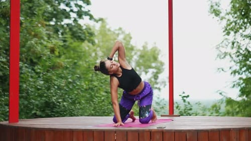 Woman Doing Yoga On Platform Outdoors
