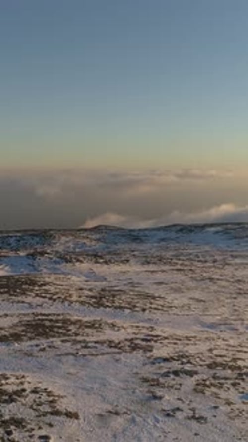 Vertical Video of Snow Mountains at Sunset Aerial