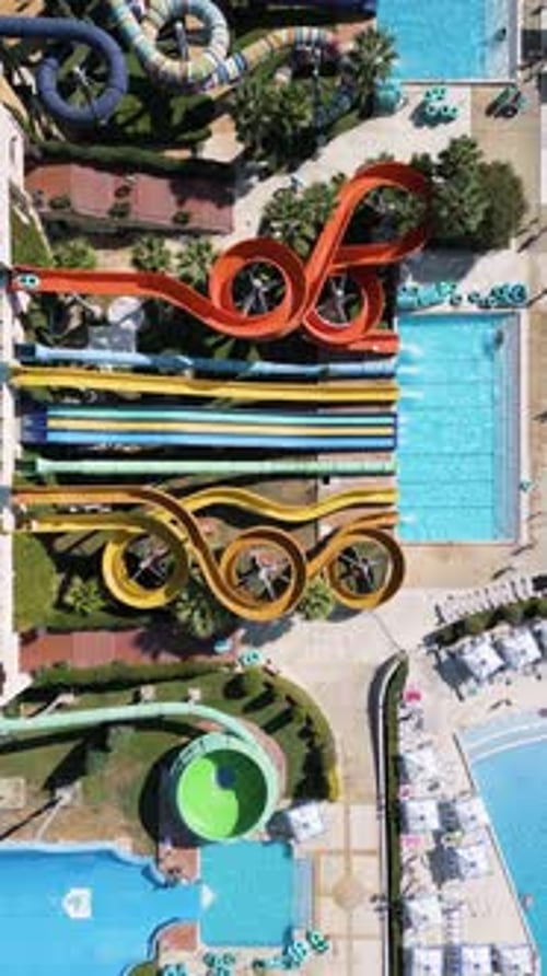 Stunning Drone View of a Massive Water Park Filled with Colorful Slides Pools Splash Zones and