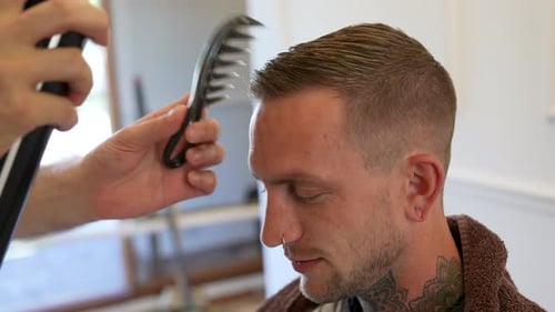 Young Man Getting Hairstyle at Barbershop