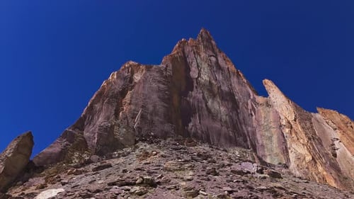 Sharp Mountain Wall Against Blue Sky Drone View