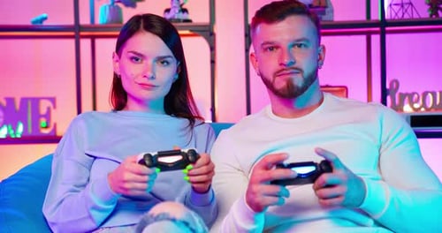 Gamers Play Joystick In Neon Room