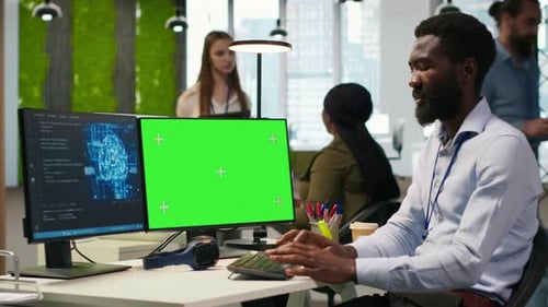 Software Developer Using AI on Green Screen Computer to Optimize Performance