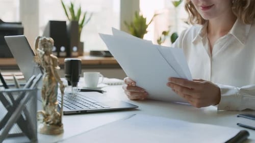 Anonymous Female Attorney Studying Documents at Law Firm