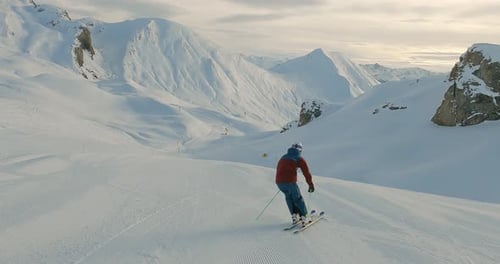 Panorama skiing on a fresh groomed ski slope with the best mountain landscape. Skiing fresh snow in