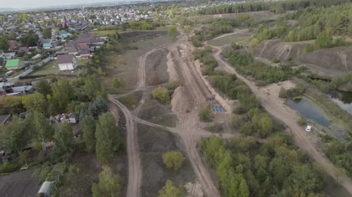 Pipelines Installed in Trench Near Village in Forest