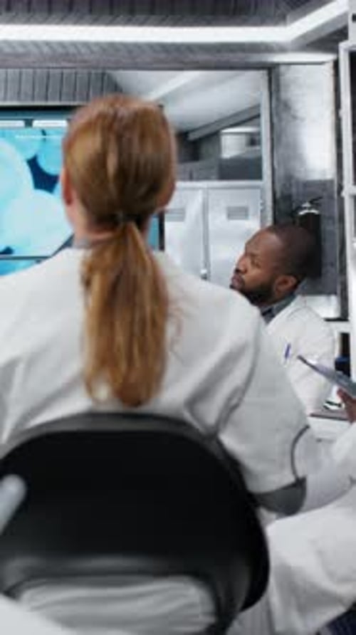 Vertical Video Senior Scientist in Lab Presents Innovative DNA Sequencing Project to Colleagues