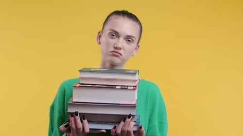 Lazy Schoolgirl Student is Dissatisfied with Amount of Books Homework on Yellow