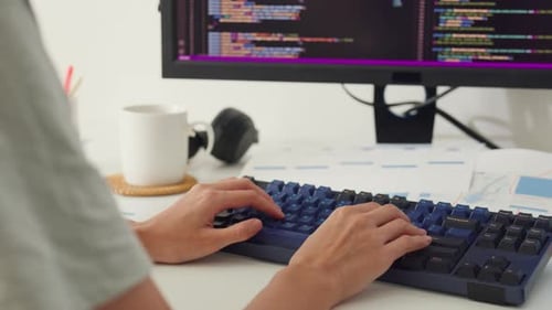 Close-up young Asia girl IT development programmer typing on keyboard coding programming.