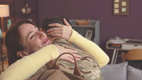 Woman Embraces Military Man in Emotional Reunion