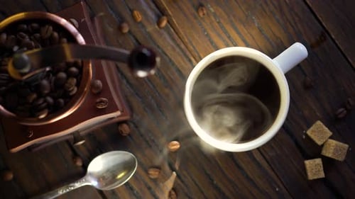 Steaming Coffee and Grinder on Wooden Table