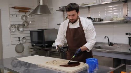 Male Chef Spreads Chocolate in Kitchen