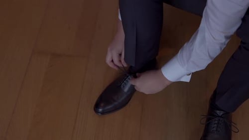 Adult Man Ties Shoelaces for Formal Event