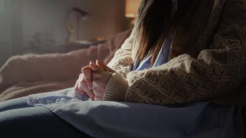 Nervous Woman Fidgets with Fingers in Psychotherapy Office