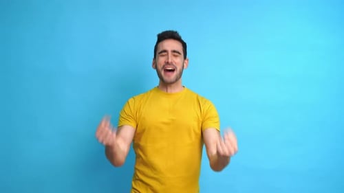 Excited Man with Raised Arms in Studio
