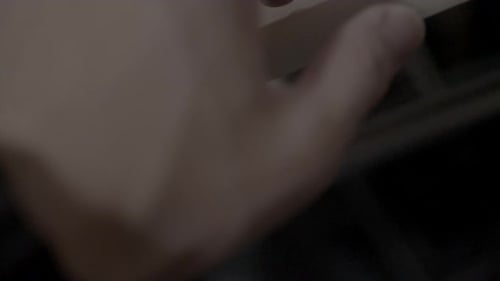 a hand picking up a pen in a cool manner