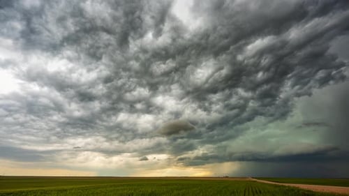 Ominous storm clouds time lapse over field